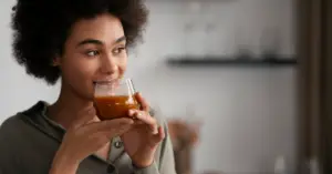 Young African woman sipping a cup of tea.