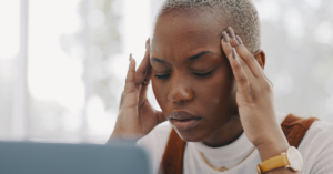 Black woman suffering from a headache.