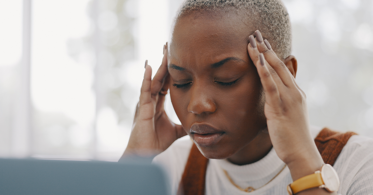 Black woman suffering from a headache.