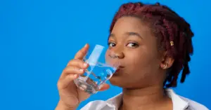 Black woman drinking water.
