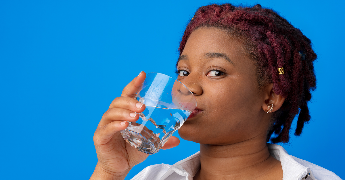 Black woman drinking water.