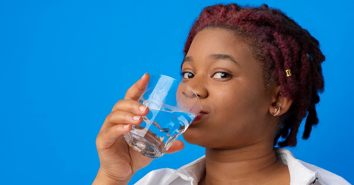 Black woman drinking water.